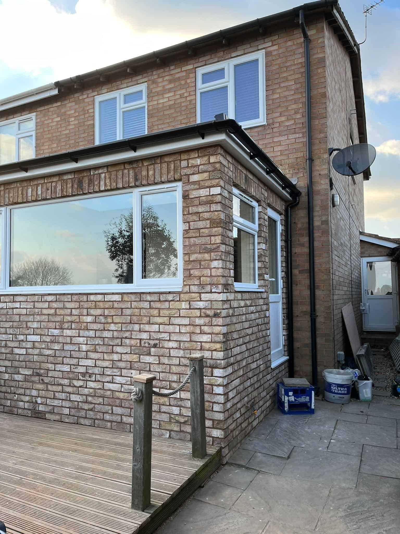 Enhanced timber-framed extension with modern brickwork for home improvement.