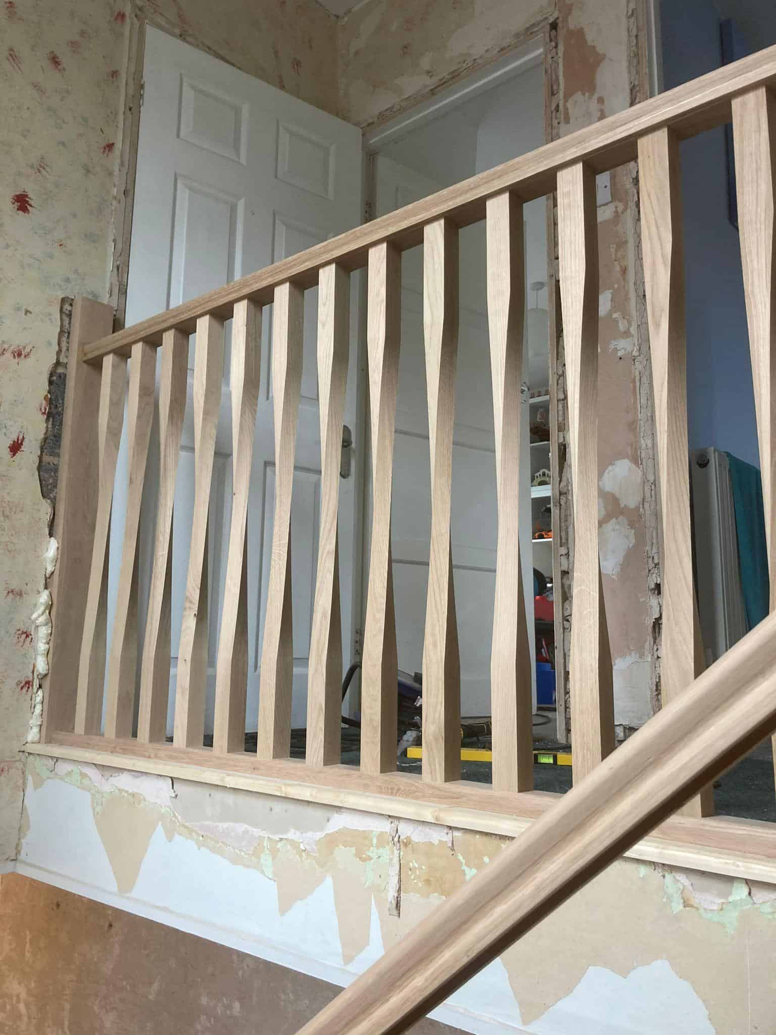 Handcrafted wooden staircase railing for interior decoration and safety in home renovation projects.