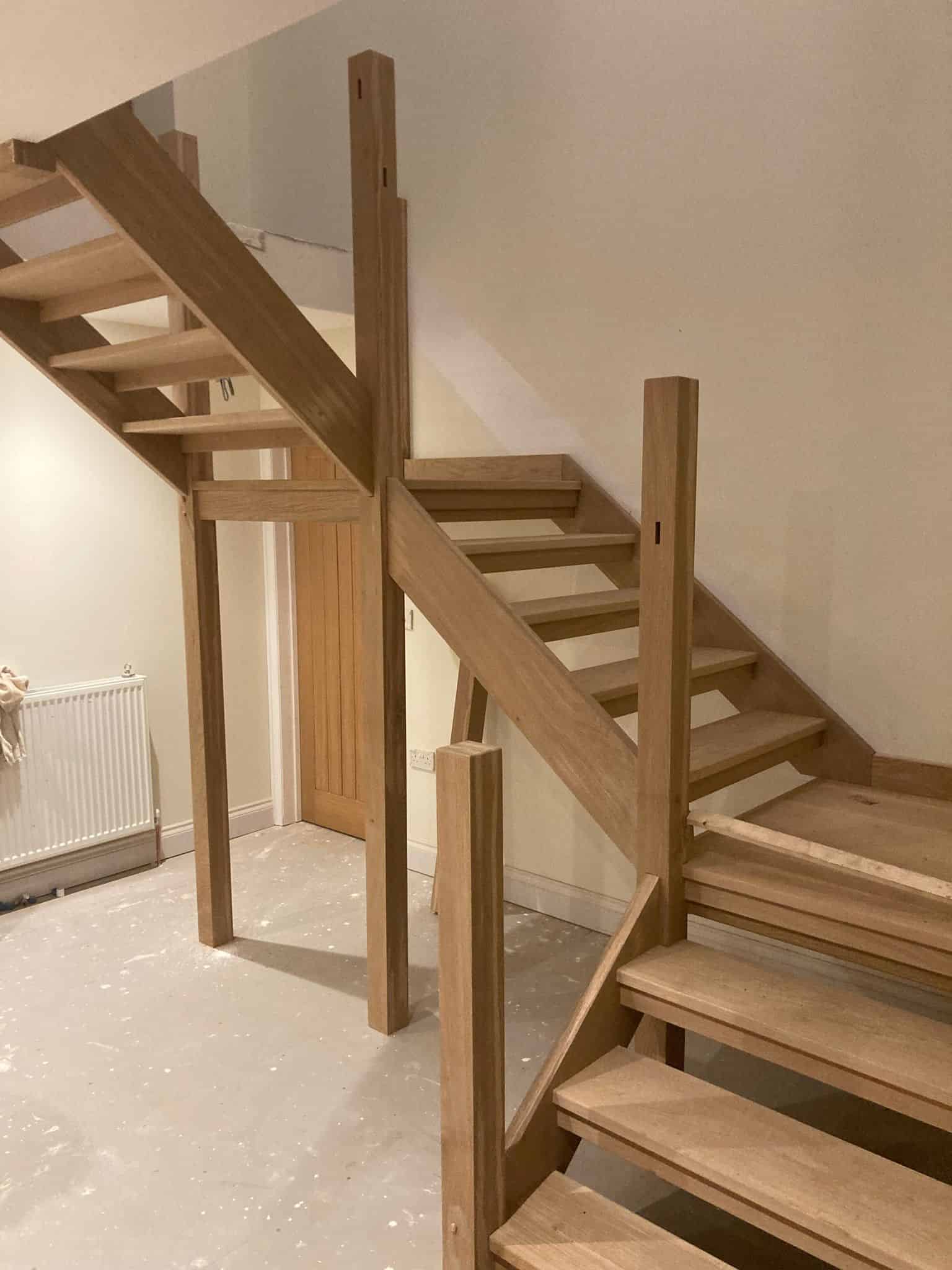 Natural wood staircase installation by JB Carpentry & Construction in the UK. Skilled craftsmanship for homes.