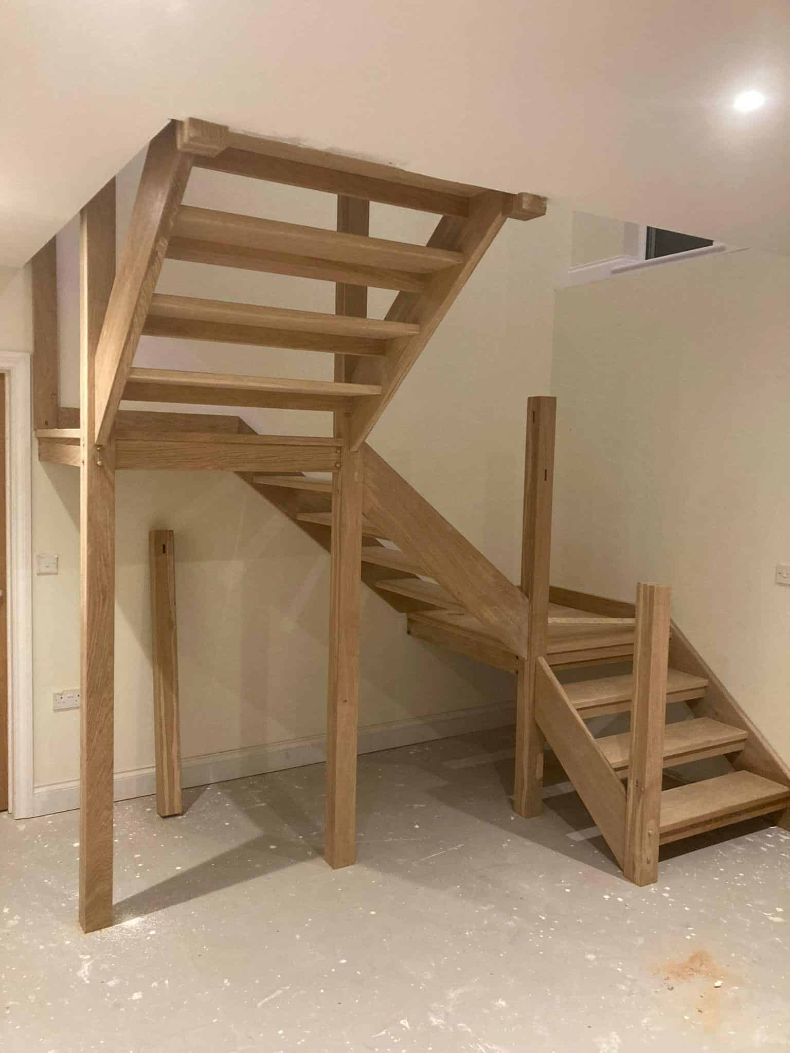 Solid timber staircase installation in a modern home by JB Carpentry & Construction, specialising in custom carpentry and building services.