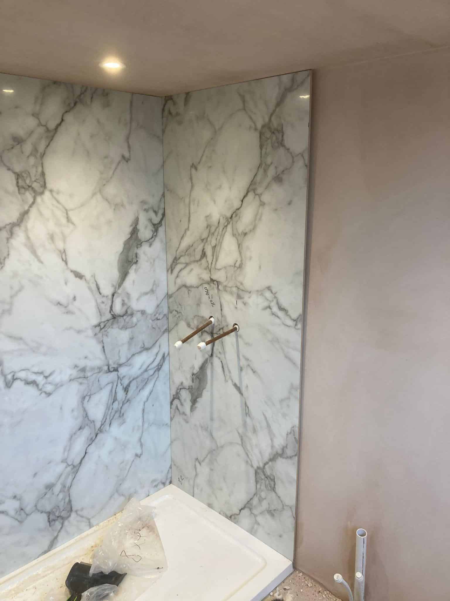 Marble wall tiling in bathroom renovation by JB Carpentry & Construction.