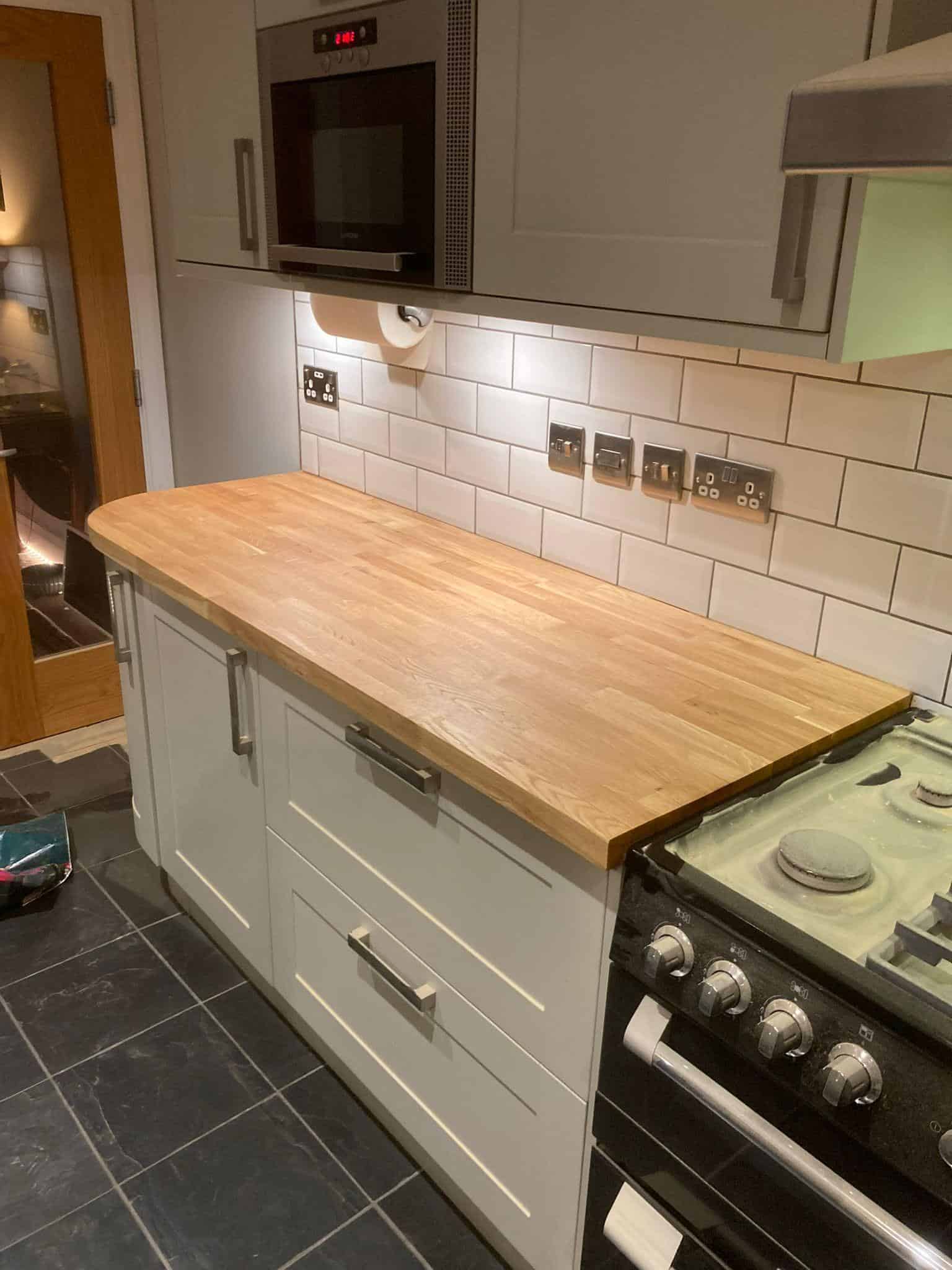Cream kitchen cabinets with wooden worktop, modern kitchen renovation by JB Carpentry & Construction.