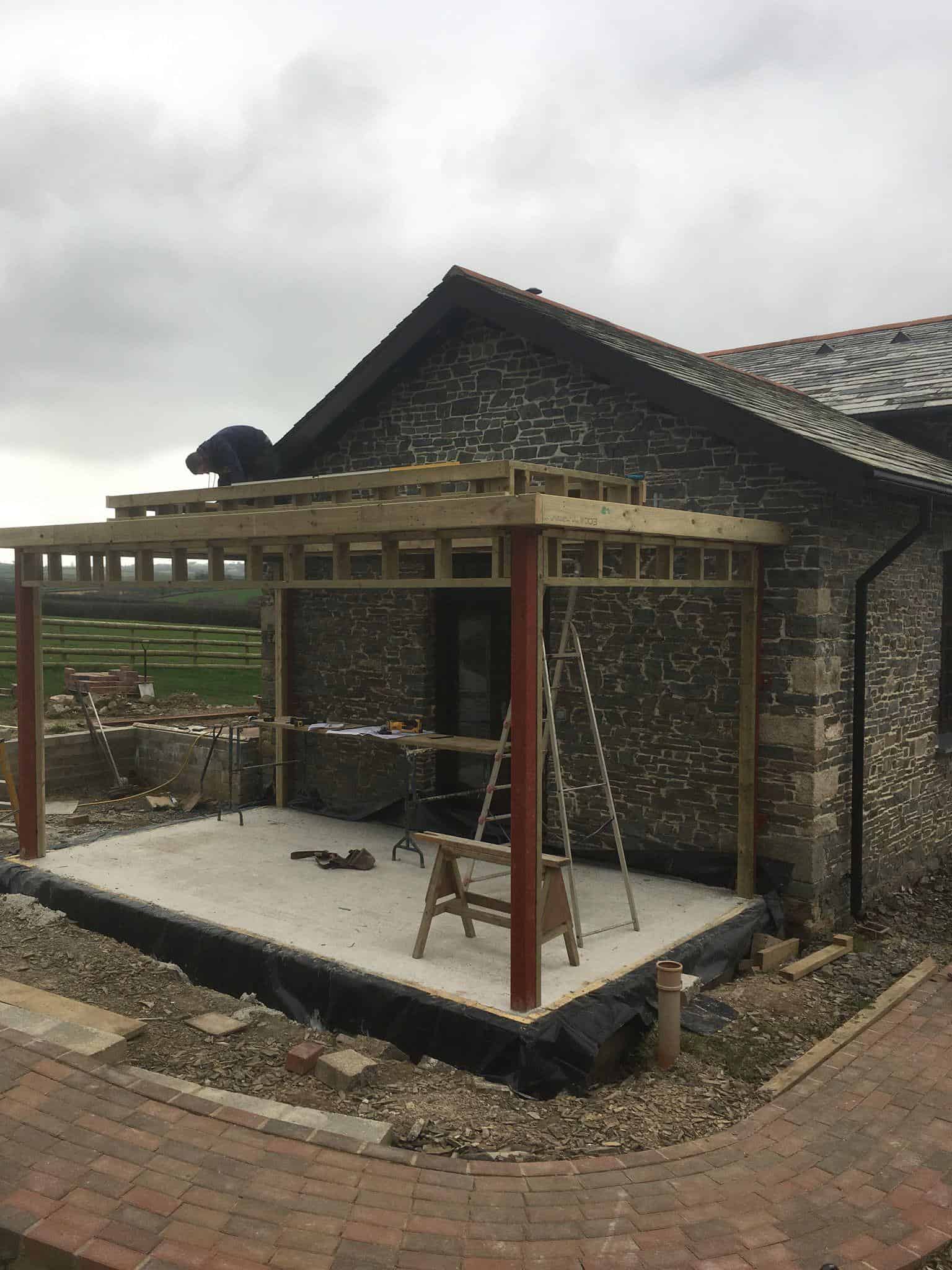 New balcony construction by JB Carpentry & Construction on a stone house in the UK.