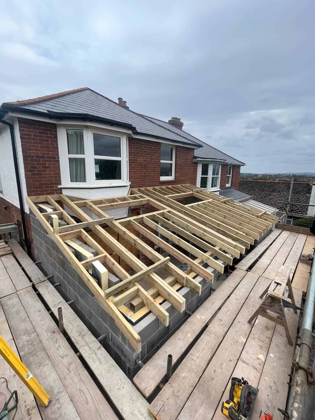 New garden deck construction with timber framing for a residential home in the UK.