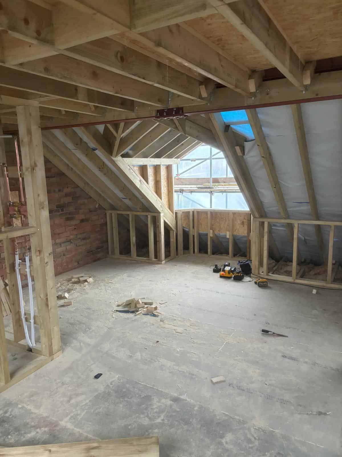 Newly constructed attic with wooden framing by JB Carpentry & Construction.