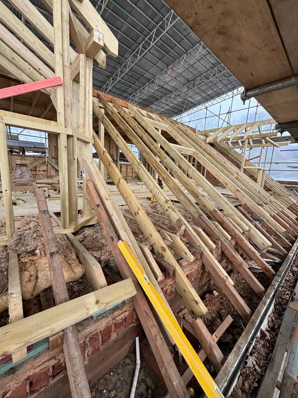 Timber roof structure under construction for a residential building by JB Carpentry & Construction. Expert carpentry and construction services in the UK.
