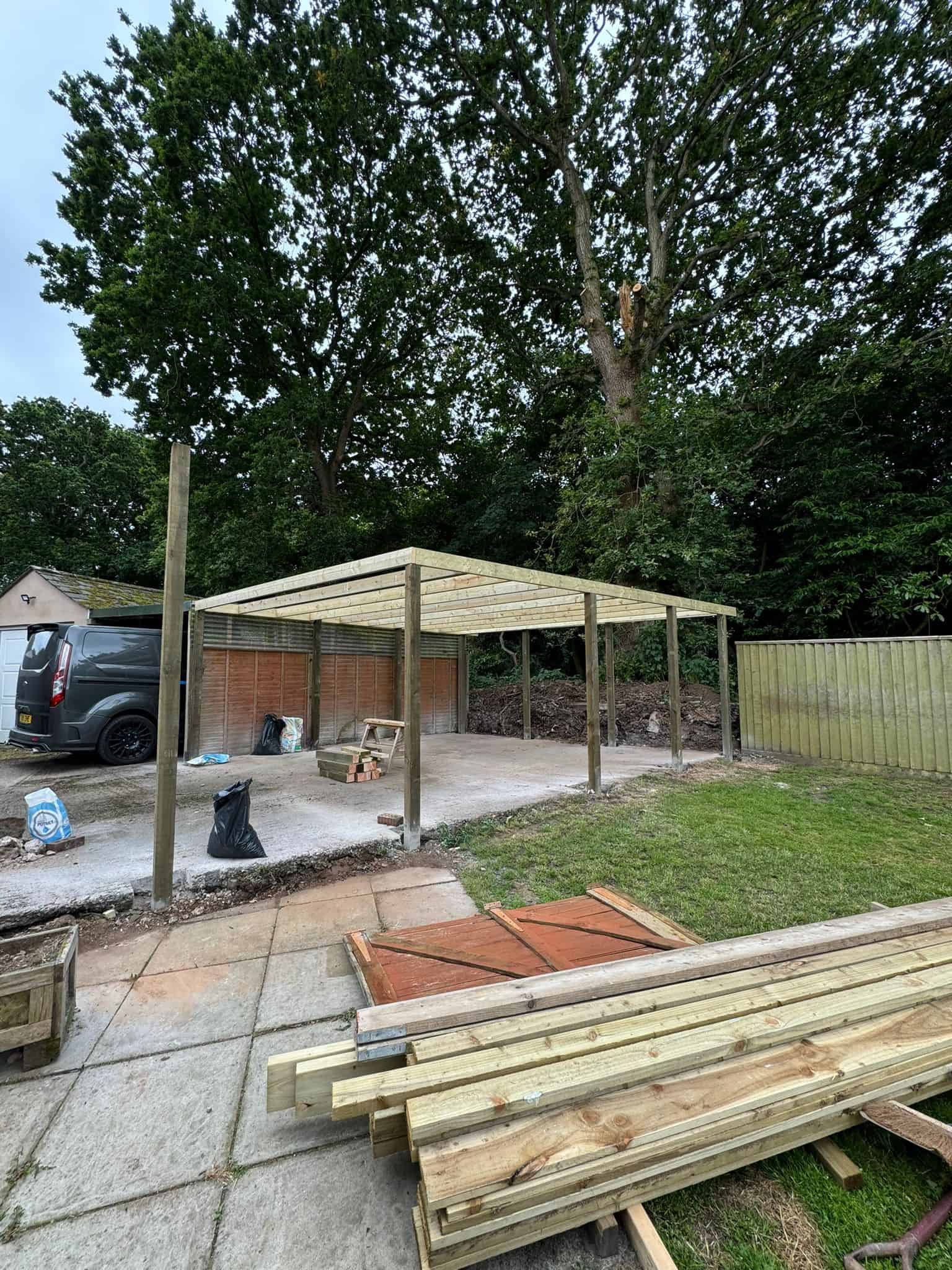 Wooden garden canopy construction by JB Carpentry & Construction, expert in outdoor carpentry solutions, in a backyard setting.