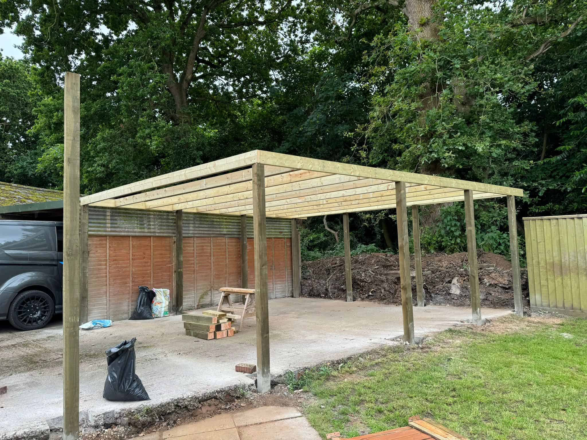 Sturdy wooden carport under construction by JB Carpentry & Construction, enhancing property’s exterior.