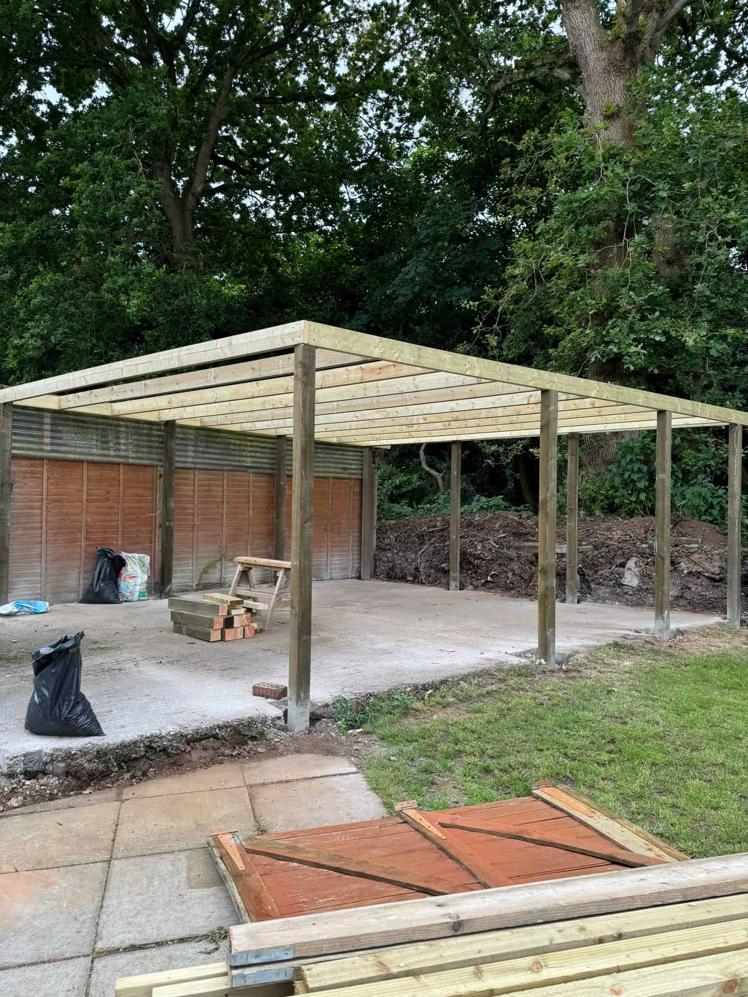 Weatherproof garden carpentry and construction in progress.