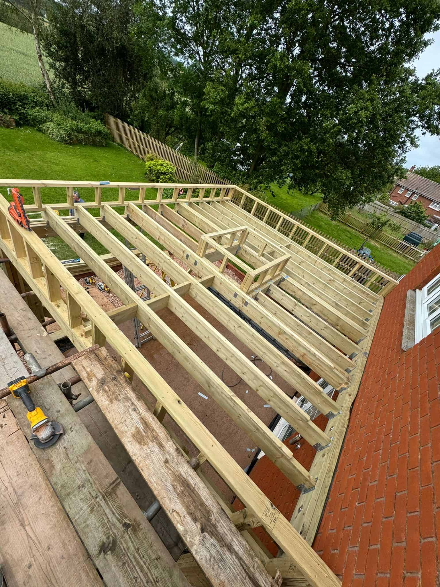New timber for garden deck construction at a residential property – expert carpentry and construction services.