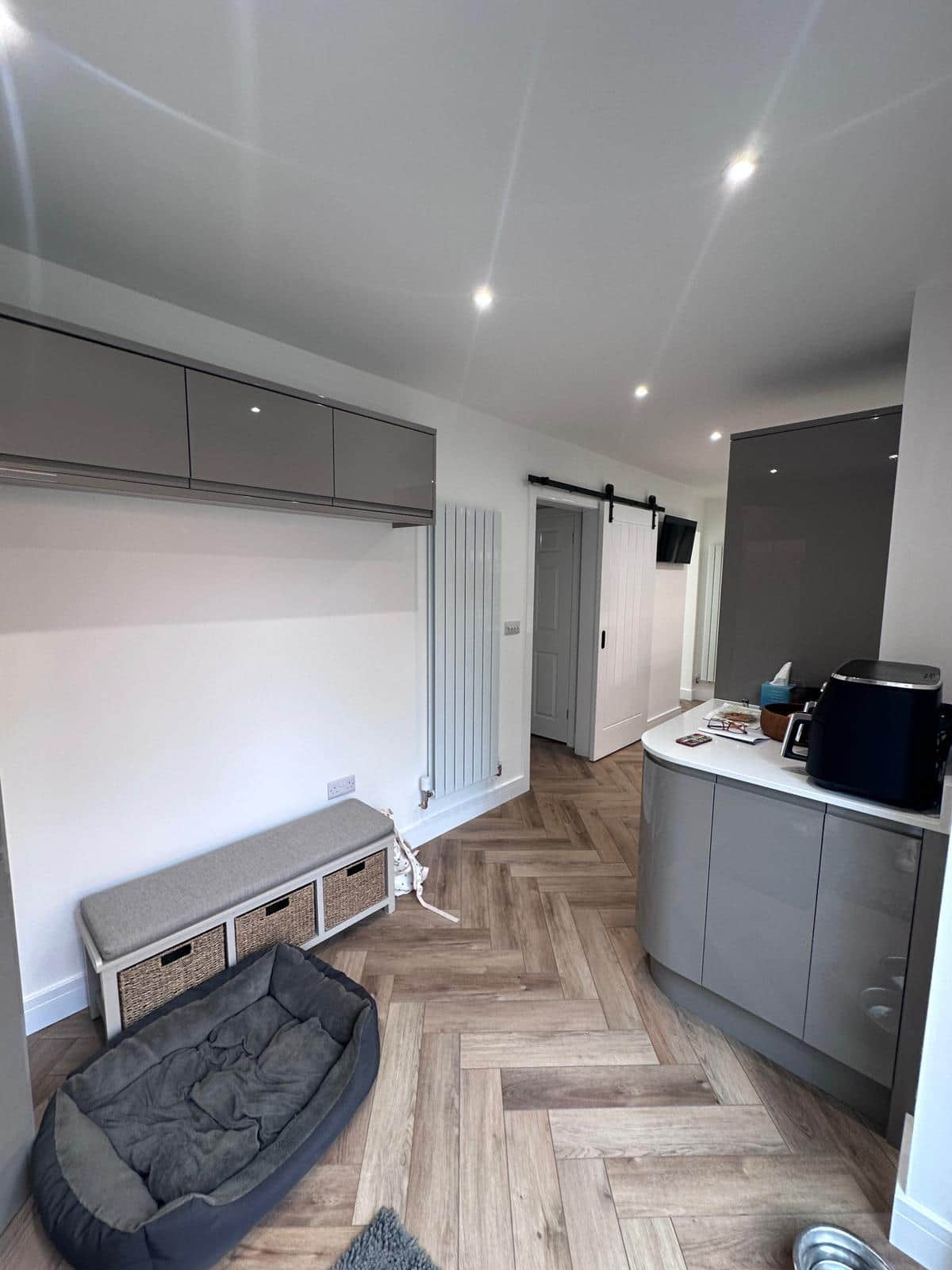 Modern kitchen and living space with bespoke carpentry by JB Carpentry & Construction, featuring custom storage, flooring, and interior fit-outs.