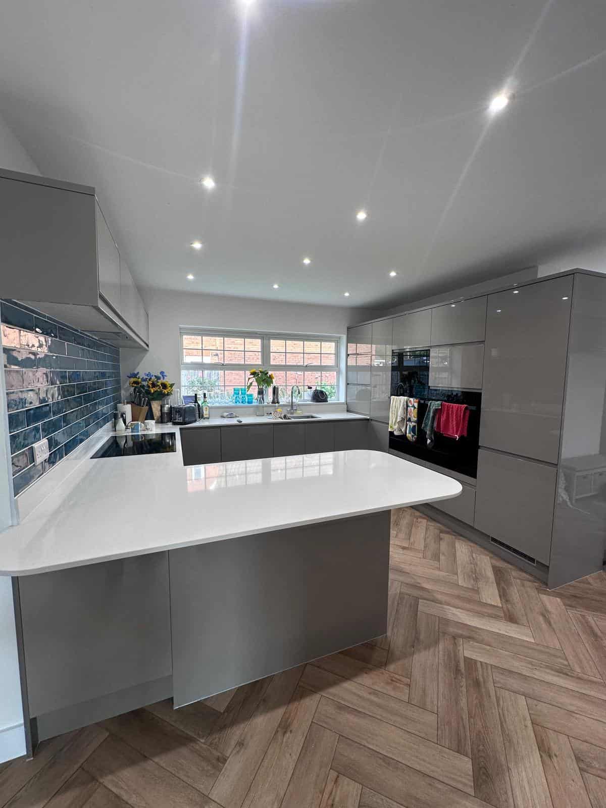 Modern grey kitchen with island and sleek cabinetry, perfect for contemporary home renovation projects.
