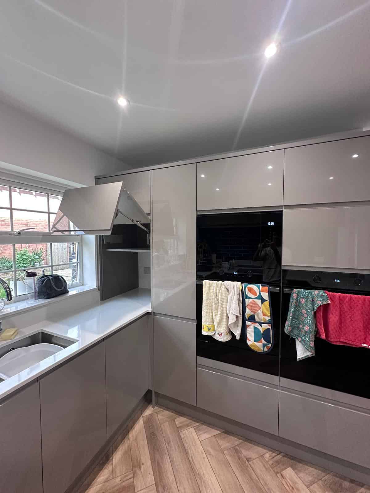 Sleek kitchen cabinetry and modern appliances by JB Carpentry & Construction, enhancing home interiors.