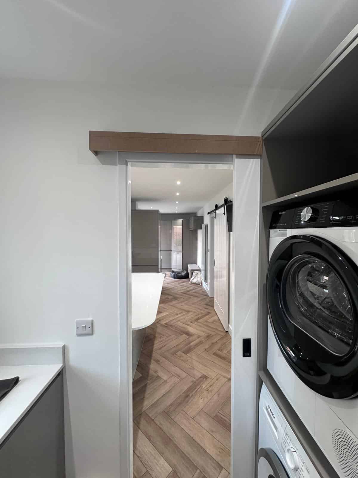 Modern laundry room with custom carpentry and storage solutions by JB Carpentry & Construction.